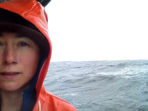 Tele Aadsen in orange raincoat at sea
